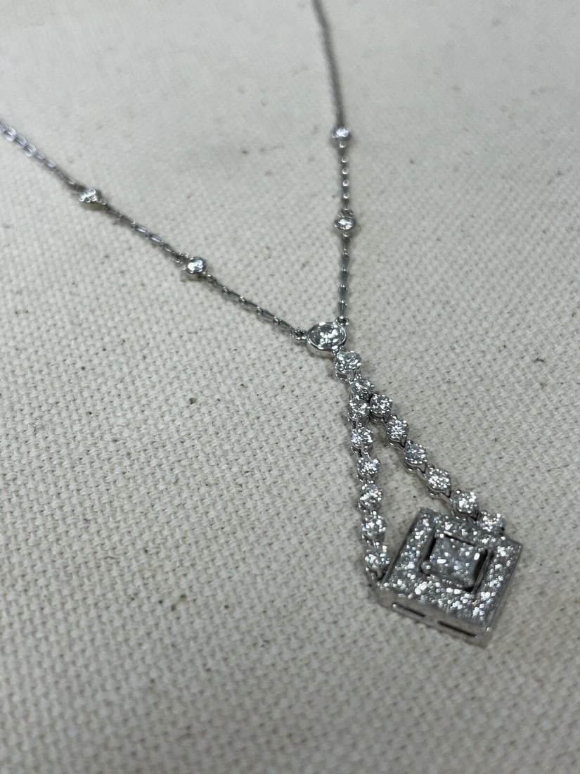 KWIAT 18K WHITE GOLD DIAMOND SWING NECKLACE: KWIAT 18K WHITE GOLD DIAMOND SWING NECKLACE Elevate any outfit with this stunning KWIAT Swing necklace Crafted from 18K white gold, it features a square pendant with 36 natural diamonds in a prong set