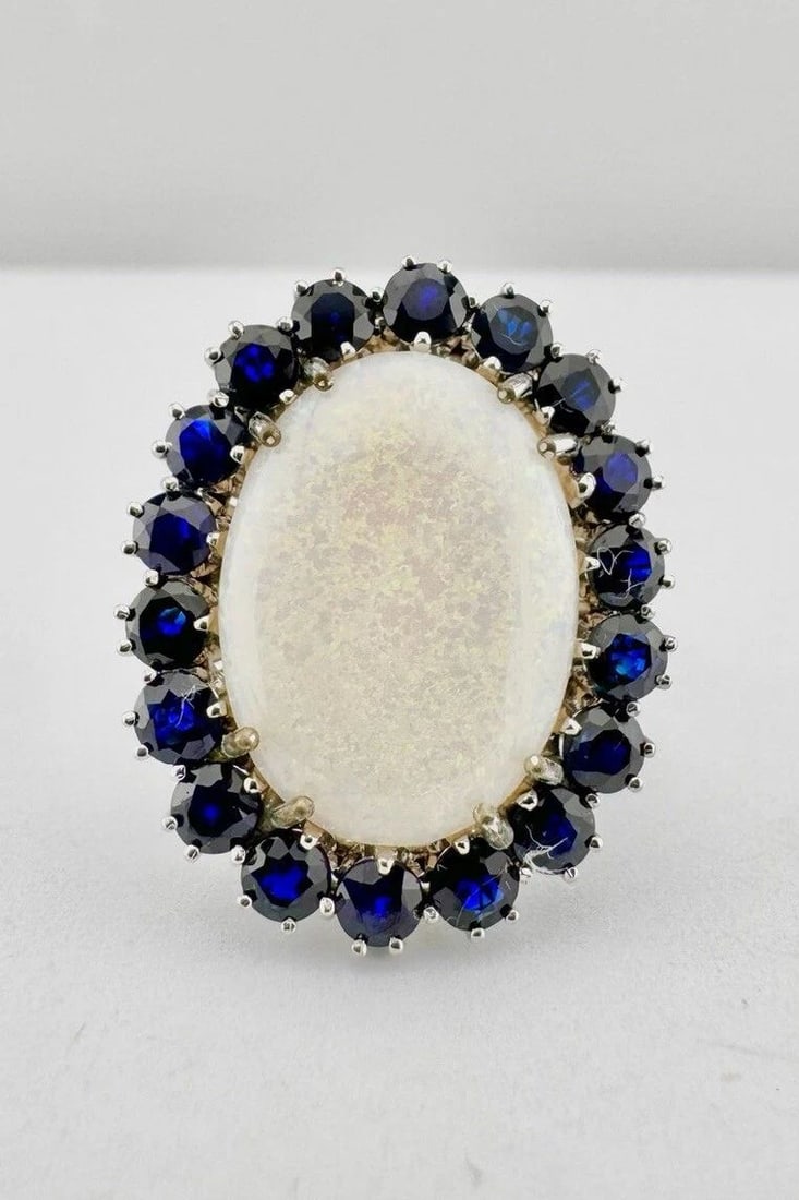 DESIGNER 18K WHITE GOLD NATURAL AUSTRALIAN FIRE OPAL & BLUE SAPPHIRE HALO RING: DESIGNER 18K WHITE GOLD NATURAL AUSTRALIAN FIRE OPAL & BLUE SAPPHIRE HALO RING Designer 18k White Gold Natural Australian Fire Opal & Blue Sapphire Halo Ring Ring Size: 8.25 - Can Be Resized Metal: 18