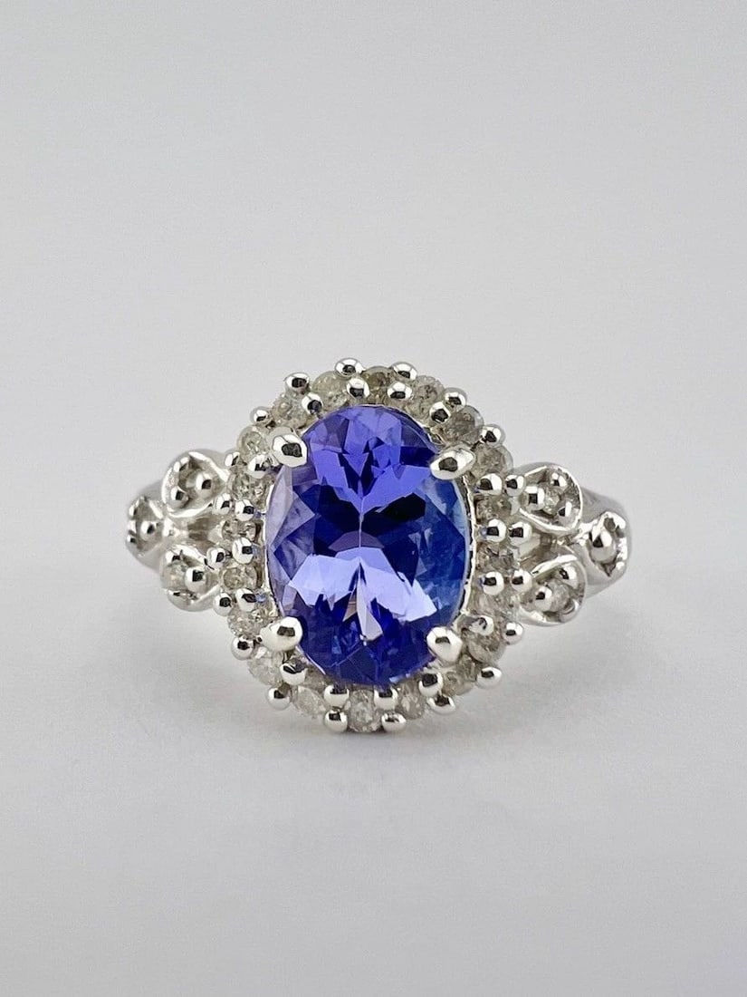 DESIGNER 14K WHITE GOLD 1.20CT OVAL TANZANITE & PAVE SET .19CT DIAMOND HALO RING: DESIGNER 14K WHITE GOLD 1.20CT OVAL TANZANITE & PAVE SET .19CT DIAMOND HALO RING Designer 14k White Gold 1.20ct Oval Tanzanite & Pave Set .19ct Diamond Halo Ring Ring Size: 6 - Can Be Resized Weight i