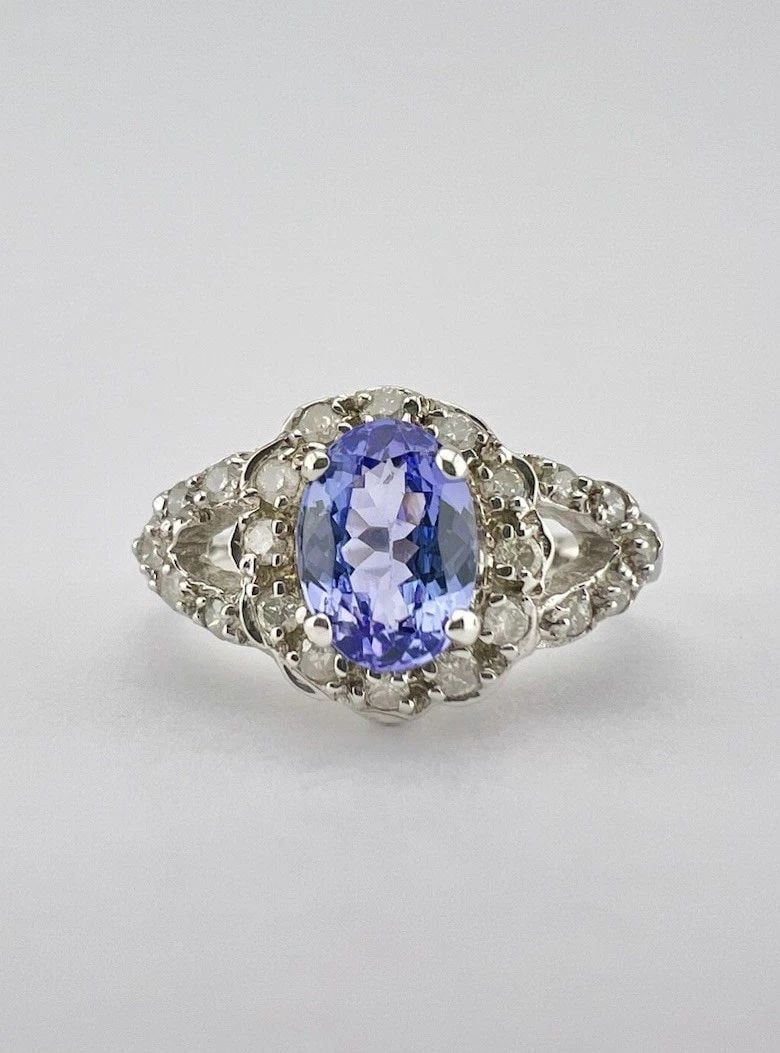 DESIGNER 14K WHITE GOLD .72CT OVAL TANZANITE & PAVE SET .28CT DIAMOND HALO RING: DESIGNER 14K WHITE GOLD .72CT OVAL TANZANITE & PAVE SET .28CT DIAMOND HALO RING Designer 14k White Gold .72ct Oval Tanzanite & Pave Set .28ct Diamond Halo Ring Ring Size: 6.25 - Can Be Resized Weight 