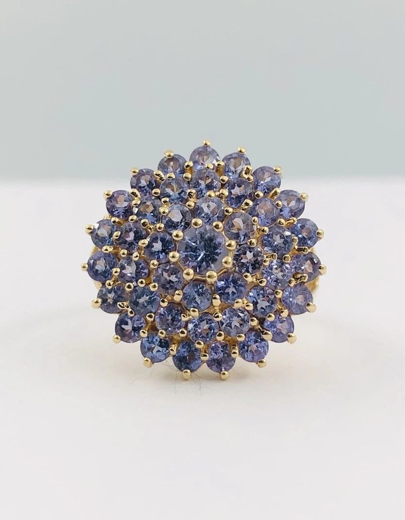 DESIGNER 14K YELLOW GOLD NATURAL PURPLE IOLITE FLORAL CLUSTER RING: DESIGNER 14K YELLOW GOLD NATURAL PURPLE IOLITE FLORAL CLUSTER RING Designer 14k Yellow Gold Natural Purple Iolite Floral Cluster Ring Size: 8 - Can Be Resized Total Weight is 5.3 Grams on my scale Met