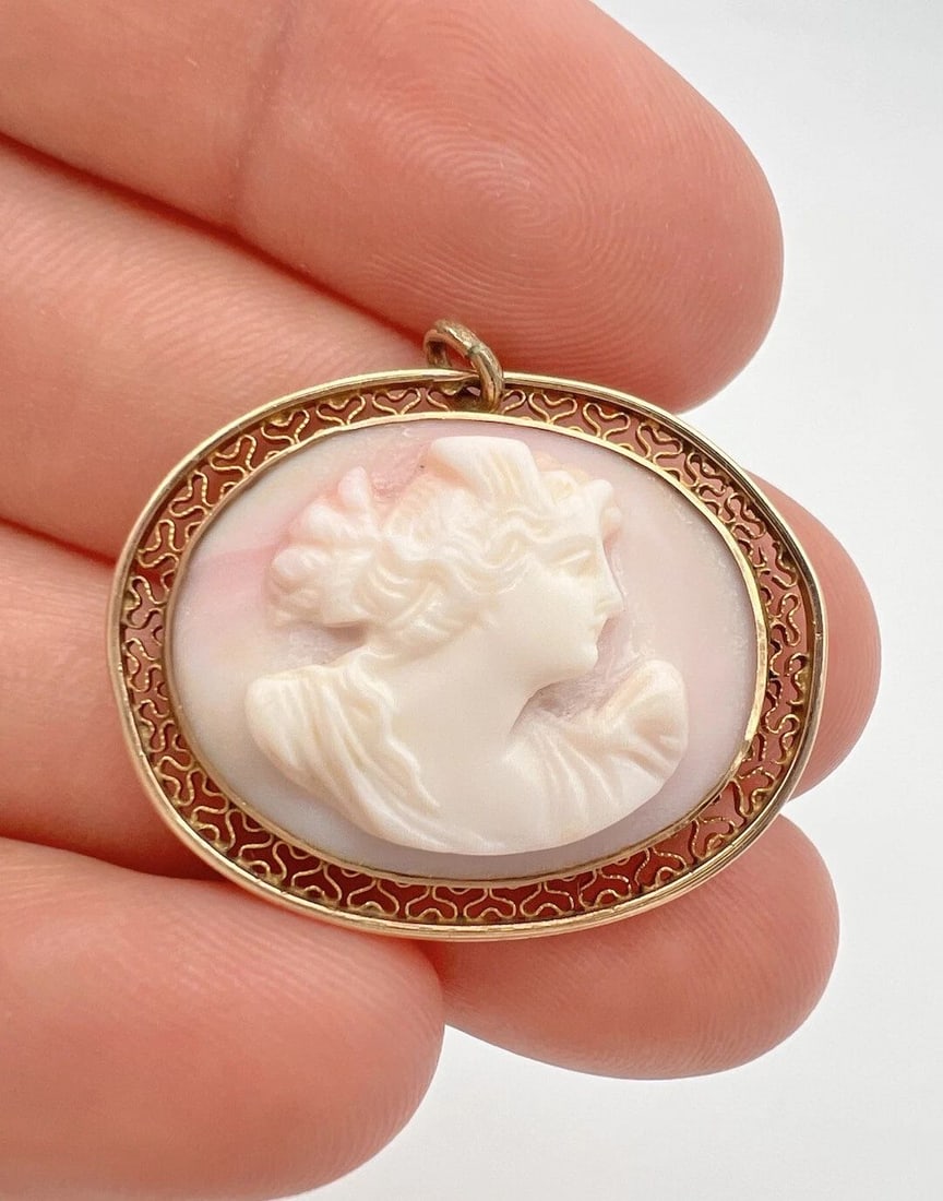 ANTIQUE VICTORIAN 10K YELLOW GOLD CARVED CORAL CAMEO FILIGREE PENDANT: ANTIQUE VICTORIAN 10K YELLOW GOLD CARVED CORAL CAMEO FILIGREE PENDANT Antique Victorian 10k Yellow Gold Carved Coral Cameo Filigree Pendant Size: 1 1/8" Tall With Bail By 1 1/4" Wide Weight is 4.9 Gra