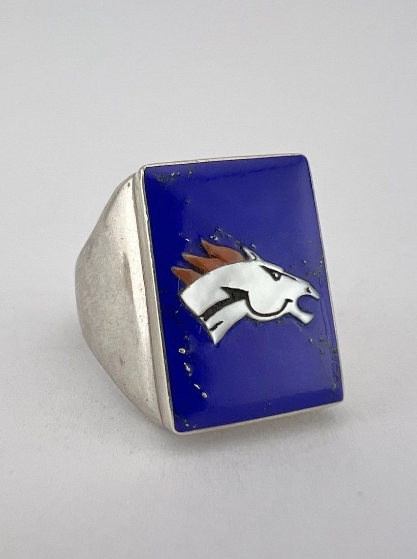 VTG BOBBY CONCHO ZUNI MULTI-INLAY STERLING SILVER DENVER BRONCOS FOOTBALL RING: VTG BOBBY CONCHO ZUNI MULTI-INLAY STERLING SILVER DENVER BRONCOS FOOTBALL RING Vtg Bobby Concho Zuni Multi-Inlay Sterling Silver Denver Broncos Football Ring Ring Size: 10.5 - Can Be Re Sized Weight i