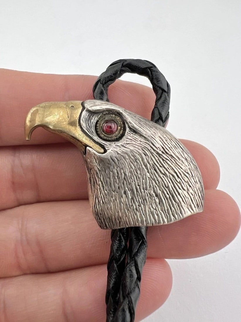VTG NAVAJO SOUTHWEST STERLING SILVER & BRONZE STAMPED EAGLE BOLO TIE - SIGNED: VTG NAVAJO SOUTHWEST STERLING SILVER & BRONZE STAMPED EAGLE BOLO TIE - SIGNED Vtg Navajo Southwest Sterling Silver & Bronze Stamped Eagle Bolo Tie - Signed Size: 1 1/8" Tall by Around 1 1/2" Wide Weig