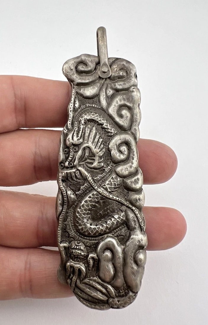 ANTIQUE QING DYNASTY CHINESE SILVER REPOUSSÉ FOLDING COMB ORNATE DRAGON PENDANT: ANTIQUE QING DYNASTY CHINESE SILVER REPOUSSÉ FOLDING COMB ORNATE DRAGON PENDANT Antique Qing Dynasty Chinese Silver Repoussé Folding Comb Ornate Dragon Pendant Size: 3 3/4" Tall from Top to the Bott