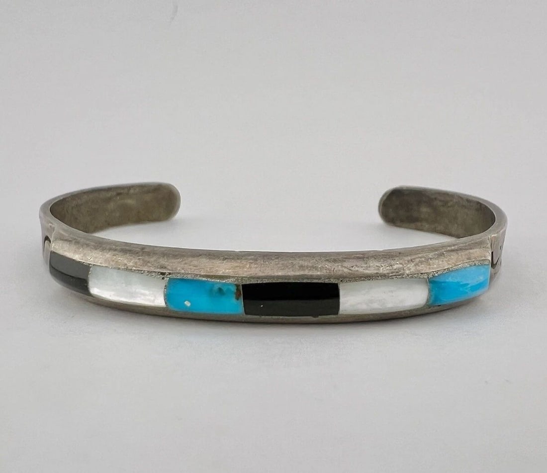 VTG NAVAJO STERLING SILVER TURQUOISE JET MOTHER OF PEARL STAMPED CUFF BRACELET: VTG NAVAJO STERLING SILVER TURQUOISE JET MOTHER OF PEARL STAMPED CUFF BRACELET Vtg Navajo Sterling Silver Turquoise Jet Mother Of Pearl Stamped Cuff Bracelet Cuff is 5" tip to Tip and has a 1 3/8" Wid