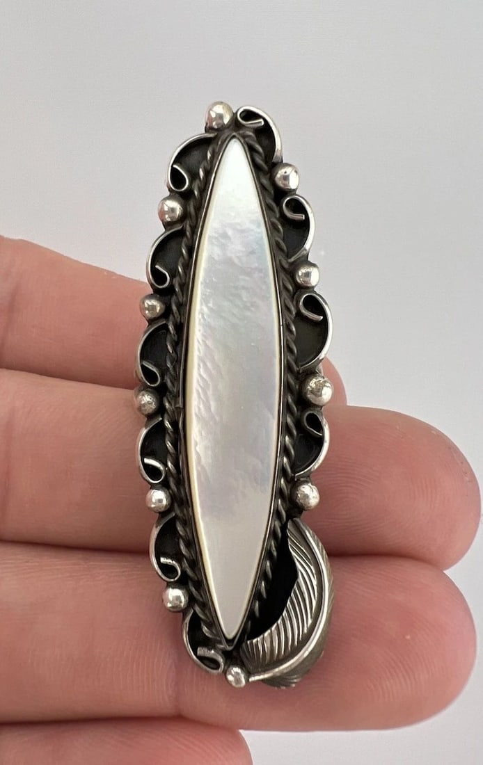 VINTAGE NAVAJO STERLING SILVER MOTHER OF PEARL STAMPED 2 1/8" LONG RING: VINTAGE NAVAJO STERLING SILVER MOTHER OF PEARL STAMPED 2 1/8" LONG RING Vintage Navajo Sterling Silver Mother Of Pearl Stamped 2 1/8" Long Ring Size: 7 - Can Be Re Sized Weight is 9.5 Grams on my scal