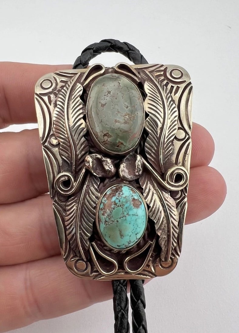 VINTAGE NAVAJO NICKEL SILVER HIGH GRADE SPIDERWEB TURQUOISE STAMPED BOLO TIE: VINTAGE NAVAJO NICKEL SILVER HIGH GRADE SPIDERWEB TURQUOISE STAMPED BOLO TIE Vintage Navajo Nickel Silver High Grade Kingman Turquoise Stamped Bolo Tie Size: 2 1/4" Tall by Around 1 3/4" Wide Weight i