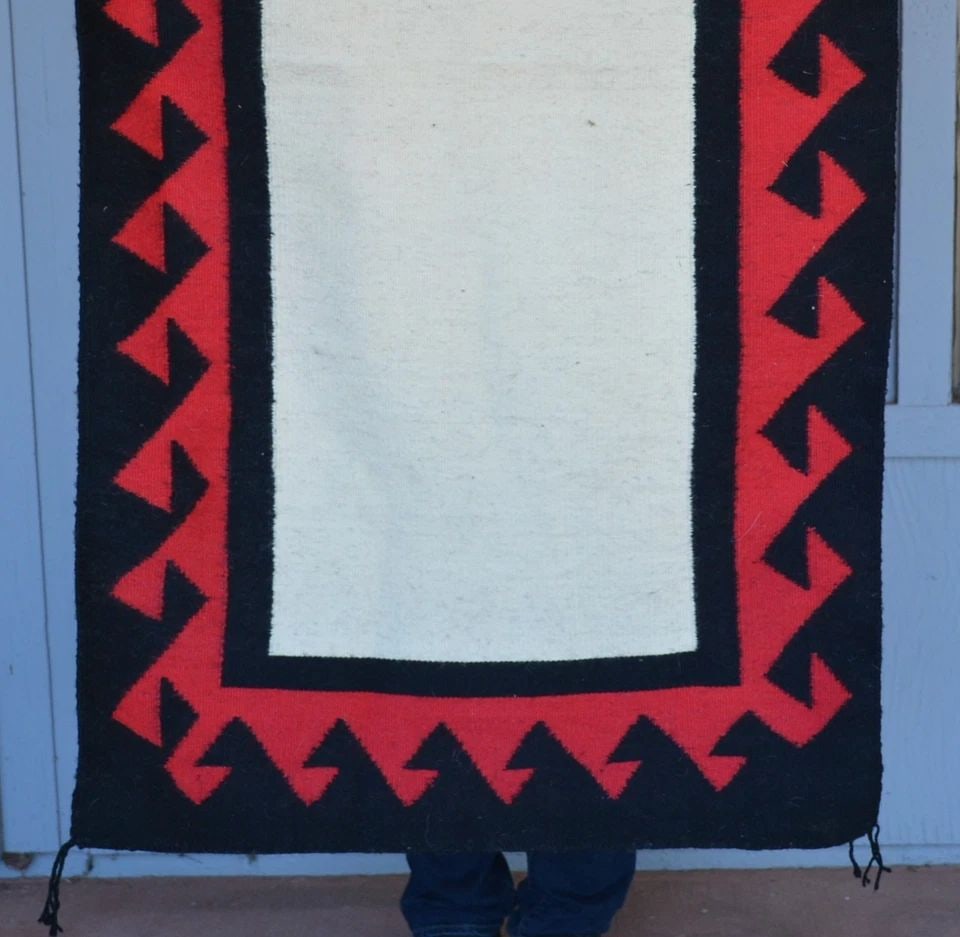 OPEN FIELD DOUBLE SADDLE BLANKET NAVAJO RUG - FISH HOOK BORDER - 58" X 30.5": OPEN FIELD DOUBLE SADDLE BLANKET NAVAJO RUG - FISH HOOK BORDER - 58" X 30.5" This double saddle blanket Navajo rug measures 58" x 30.5". It shows an open field at the center surrounded by a wide fish 