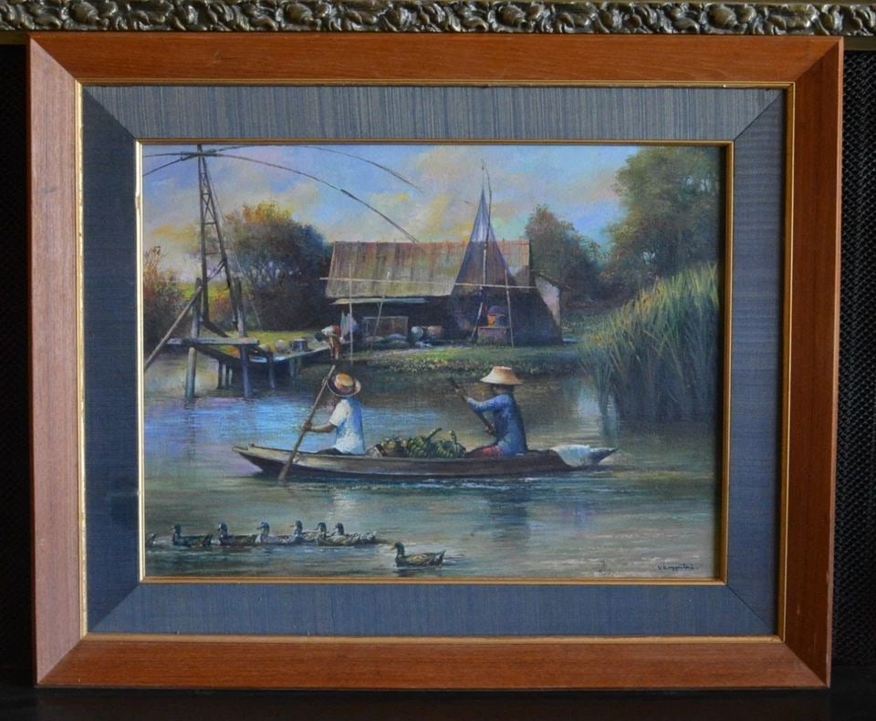 VTG PAINTING - RIVERSIDE VILLAGE LIFE THAILAND SOUTHEAST ASIA - SIGNED FRAMED: VTG PAINTING - RIVERSIDE VILLAGE LIFE THAILAND SOUTHEAST ASIA - SIGNED FRAMED This vintage painting shows a peaceful scene of riverside village life in Thailand. It looks to be oil on board. It is sig