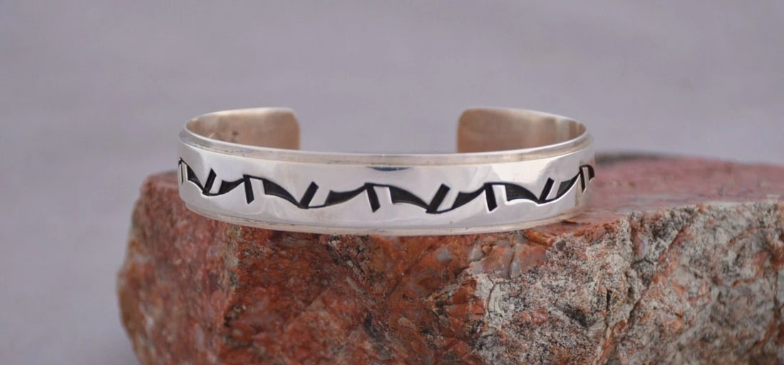 AUGUSTINE MOWA - HOPI STERLING SILVER CUFF BRACELET - UNIQUE DESIGN - 6 3/4": AUGUSTINE MOWA - HOPI STERLING SILVER CUFF BRACELET - UNIQUE DESIGN - 6 3/4" This sterling silver cuff bracelet has been beautifully crafted by traditional Hopi artist Augustine Mowa Jr. This bracelet