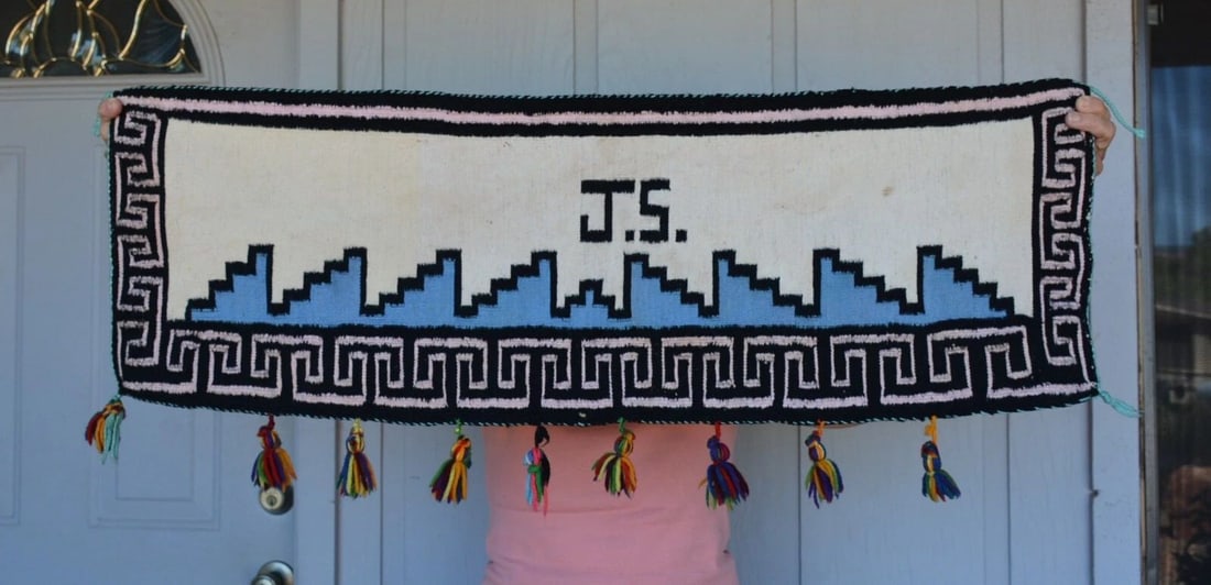 UNIQUE VINTAGE NAVAJO PICTORIAL RUG - JS WITH GREAT BORDER AND COLORFUL TASSELS: UNIQUE VINTAGE NAVAJO PICTORIAL RUG - JS WITH GREAT BORDER AND COLORFUL TASSELS This unique Navajo pictorial rug is in good condition. It measures 13" tall by 39" across. One of the colorful tassels o