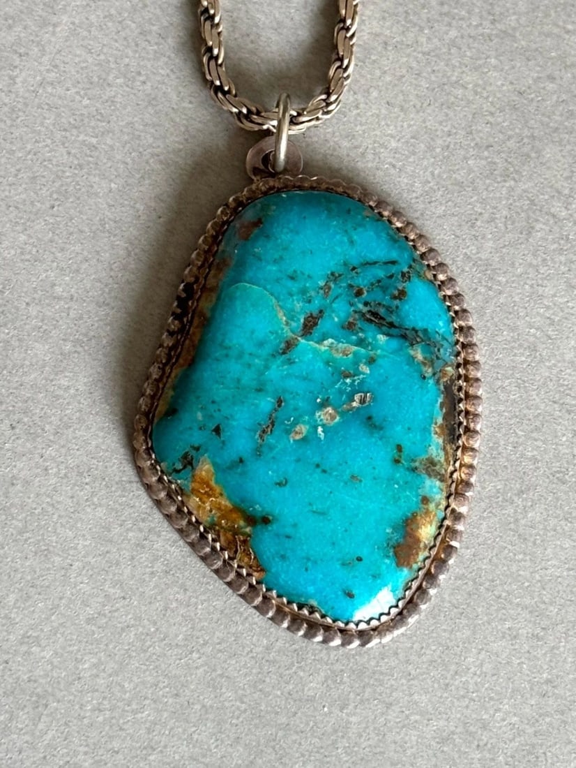 VINTAGE NAVAJO STERLING SILVER WITH LARGE TURQUOISE PENDANT ON STERLING CHAIN: VINTAGE NAVAJO STERLING SILVER WITH LARGE TURQUOISE PENDANT ON STERLING CHAIN Vintage Navajo Sterling Silver with Large Turquoise Pendant on Sterling Silver Chain Pendant is 2 1/4" 18" Chain .. 32.6 G