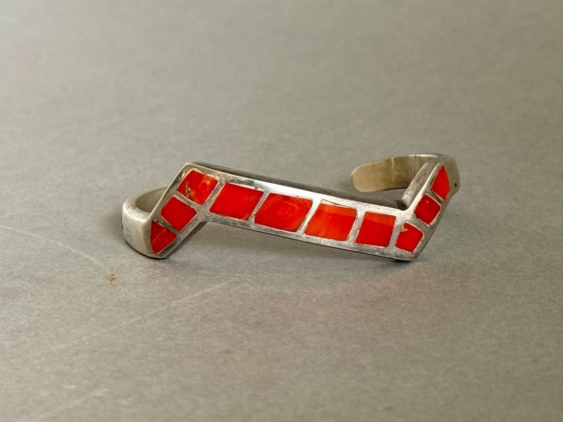 VINTAGE ZUNI STERLING SILVER WITH INLAID CORAL BRACELET: VINTAGE ZUNI STERLING SILVER WITH INLAID CORAL BRACELET Vintage Zuni Sterling Silver with Inlaid Coral Bracelet 3/8" Wide x 3/16 Thick ..weighs 34 Grams Has a silver repair on the side of bracelet is 