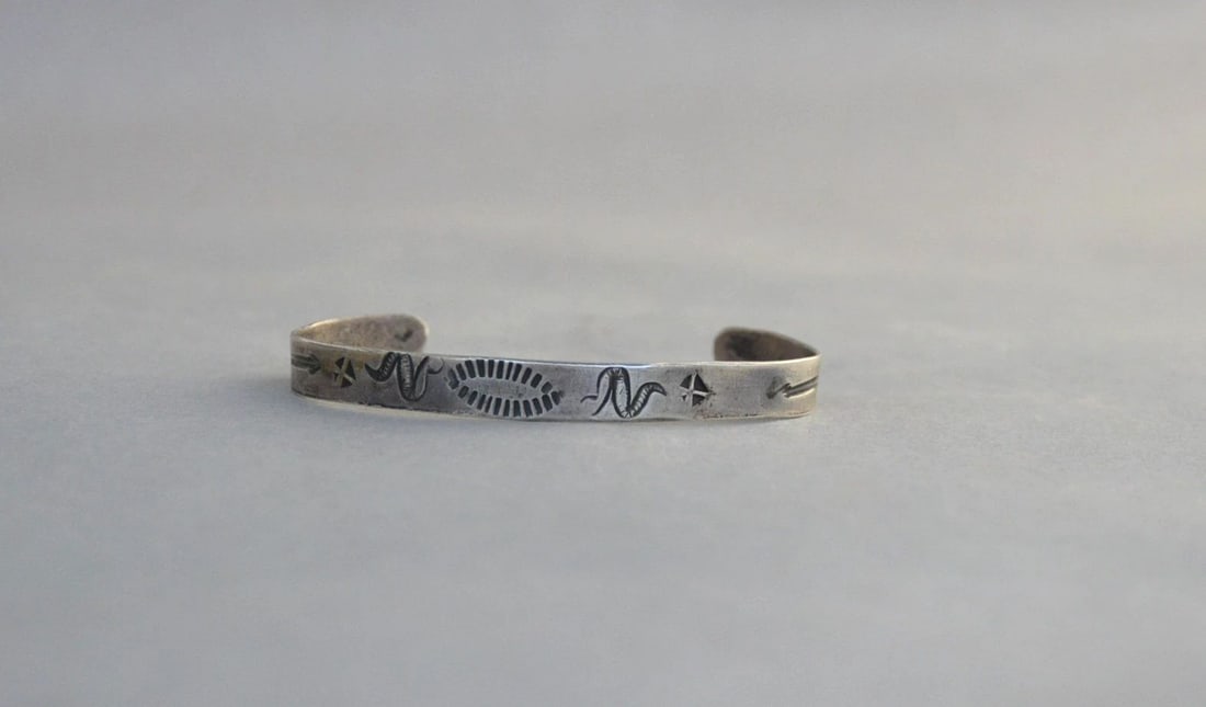 UNIQUE OLD PAWN NAVAJO-HOPI HANDSTAMPED STERLING SILVER BRACELET -: UNIQUE OLD PAWN NAVAJO-HOPI HANDSTAMPED STERLING SILVER BRACELET - This Hopi silver bracelet has some unusual handstamped symbols, including 4 snakes, crosses, arrows and sunrays at the center. (The N