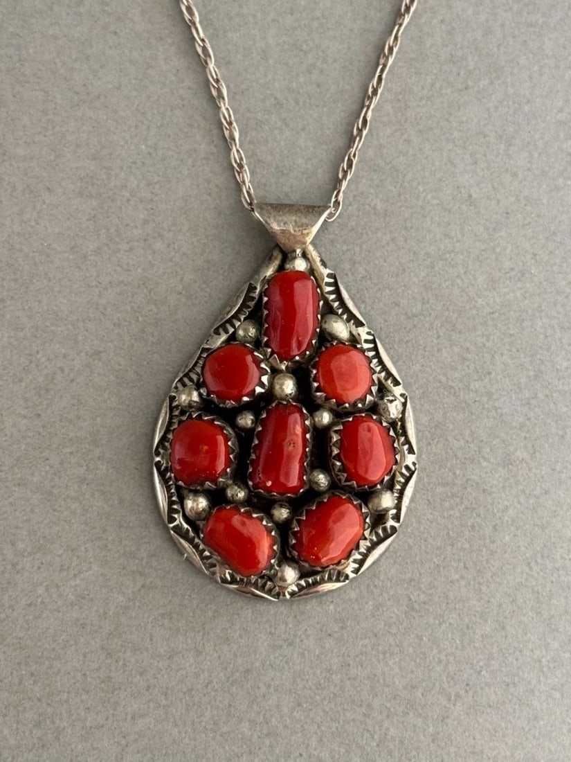 VINTAGE NAVAJO STERLING SILVER AND CORAL PENDANT ON STERLING CHAIN: VINTAGE NAVAJO STERLING SILVER AND CORAL PENDANT ON STERLING CHAIN Vintage Navajo Sterling Silver and Coral Pendant on Sterling Silver Chain 1 3/8" Tall .. Chain is 22"
