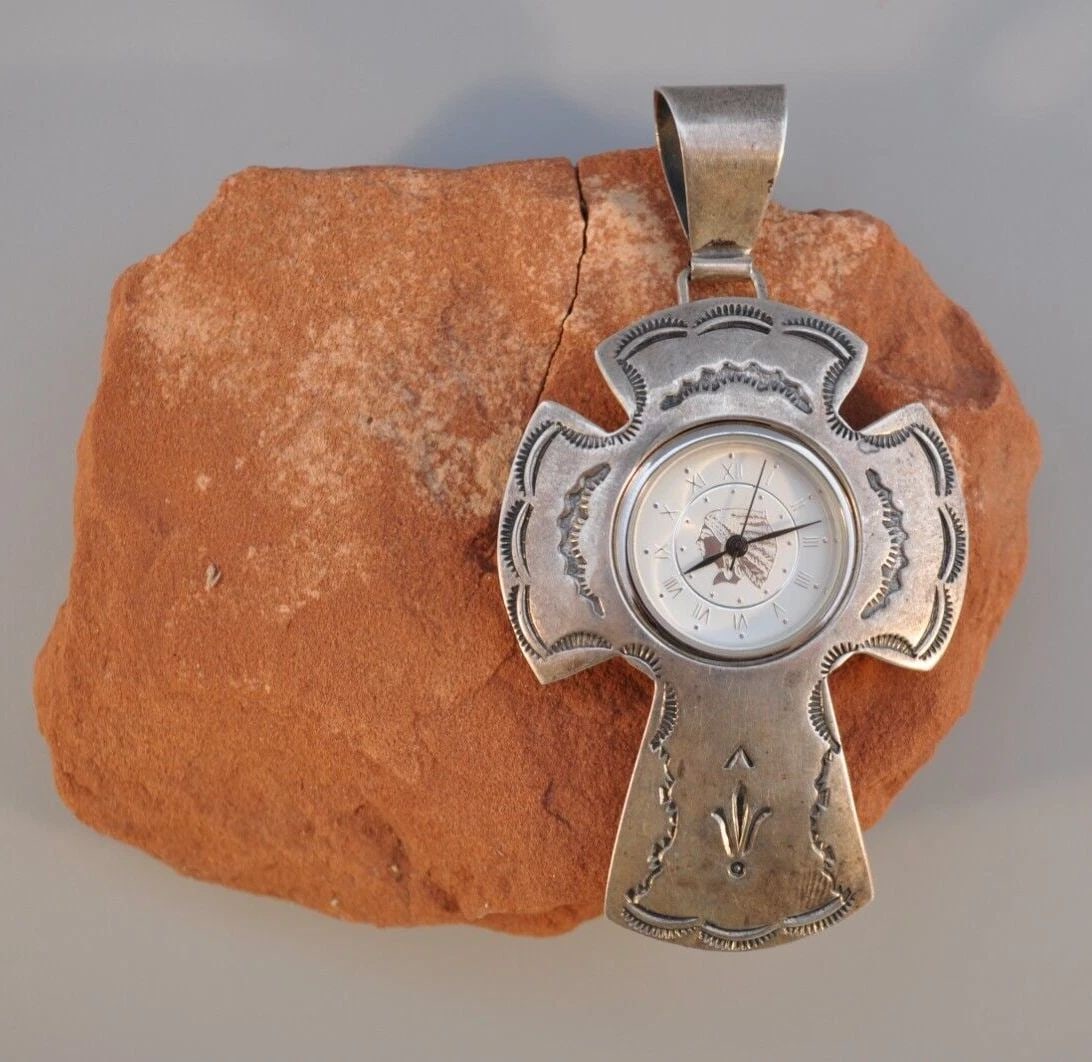 VINTAGE NAVAJO STERLING SILVER CROSS WATCH PENDANT SAM W.: VINTAGE NAVAJO STERLING SILVER CROSS WATCH PENDANT SAM W. Weight 23.34 Grams Like new 3 1/4" Tall 1 5/8" Wide ..Watch doesnt work Might need a new battery..
