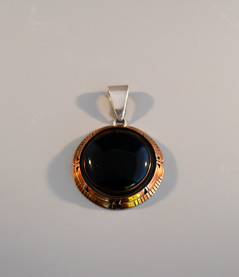 LARGE NAVAJO STERLING SILVER PENDANT - BEAUTIFUL BLACK ONYX STONE - FIJ: LARGE NAVAJO STERLING SILVER PENDANT - BEAUTIFUL BLACK ONYX STONE - FIJ Item Description: This large sterling silver pendant has a beautifully shaped and polished black onyx stone surrounded with a ha
