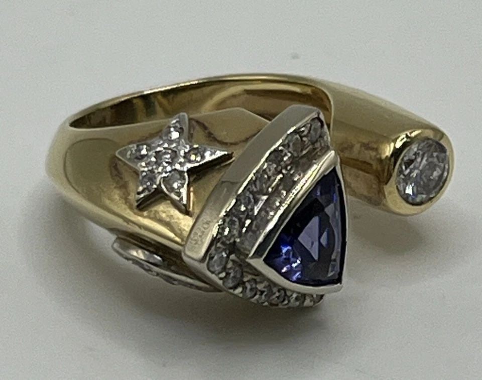 14KT YELLOW GOLD, TANZANITE & DIAMOND RING WITH MOON & STAR SIZE 3.25/3.5: 14KT YELLOW GOLD, TANZANITE & DIAMOND RING WITH MOON & STAR SIZE 3.25/3.5 14KT YELLOW GOLD, TANZANITE & DIAMOND RING WITH MOON & STAR SIZE 3.25/3.5 This stunning 14KT yellow gold ring showcases a beau