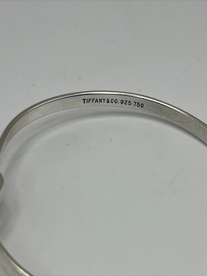 TIFFANY & CO. STERLING SILVER BRACELET WITH 18KT YELLOW GOLD ACCENTS: TIFFANY & CO. STERLING SILVER BRACELET WITH 18KT YELLOW GOLD ACCENTS TIFFANY & CO. STERLING SILVER BRACELET WITH 18KT YELLOW GOLD ACCENTS Elevate your jewelry collection with this stunning Tiffany &am