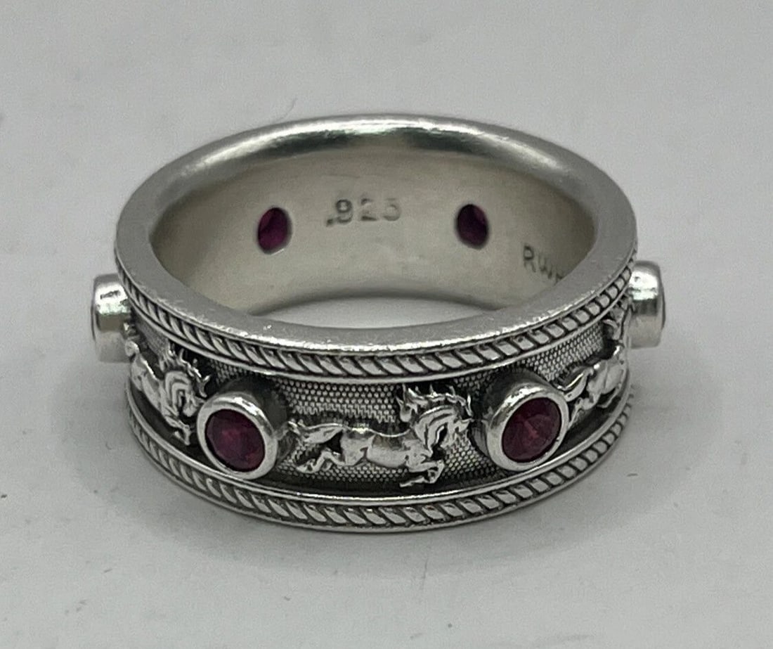 FOAL OF THE FOUR WINDS RING WITH 3MM RUBIES: FOAL OF THE FOUR WINDS RING WITH 3MM RUBIES FOAL OF THE FOUR WINDS RING WITH 3MM RUBIES Beautiful Foal of the Four Winds Sterling Silver and Ruby size 7 ringHas 6 3mm Rubies along band with figure of 