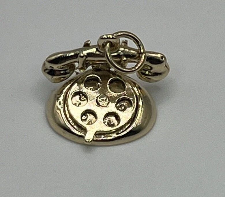14K YELLOW GOLD TELEPHONE CHARM: 14K YELLOW GOLD TELEPHONE CHARM 14K YELLOW GOLD TELEPHONE CHARM Add a touch of nostalgia to your jewelry collection with this charming 14K yellow gold telephone pendant. The vintage-inspired piece wei