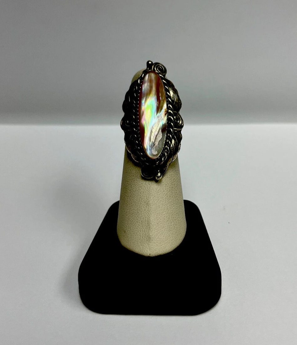 MOTHER OF PEARL STERLING SILVER RING: MOTHER OF PEARL STERLING SILVER RING MOTHER OF PEARL STERLING SILVER RING A southwest style sterling silver and mother of pearl ring. Stone is an oval cut.Approximate weight is 11.9 ozRing size is 6.2