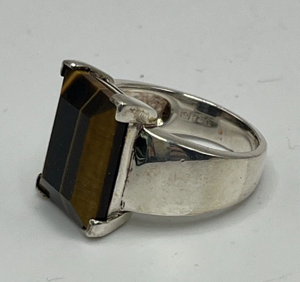 TIGER'S EYE STERLING SILVER SIZE 8: TIGER'S EYE STERLING SILVER SIZE 8 TIGER'S EYE STERLING SILVER SIZE 8 Elevate your accessory game with this exquisite Tiger's Eye Ring made of high-quality Sterling Silver. The unique multicolor stone