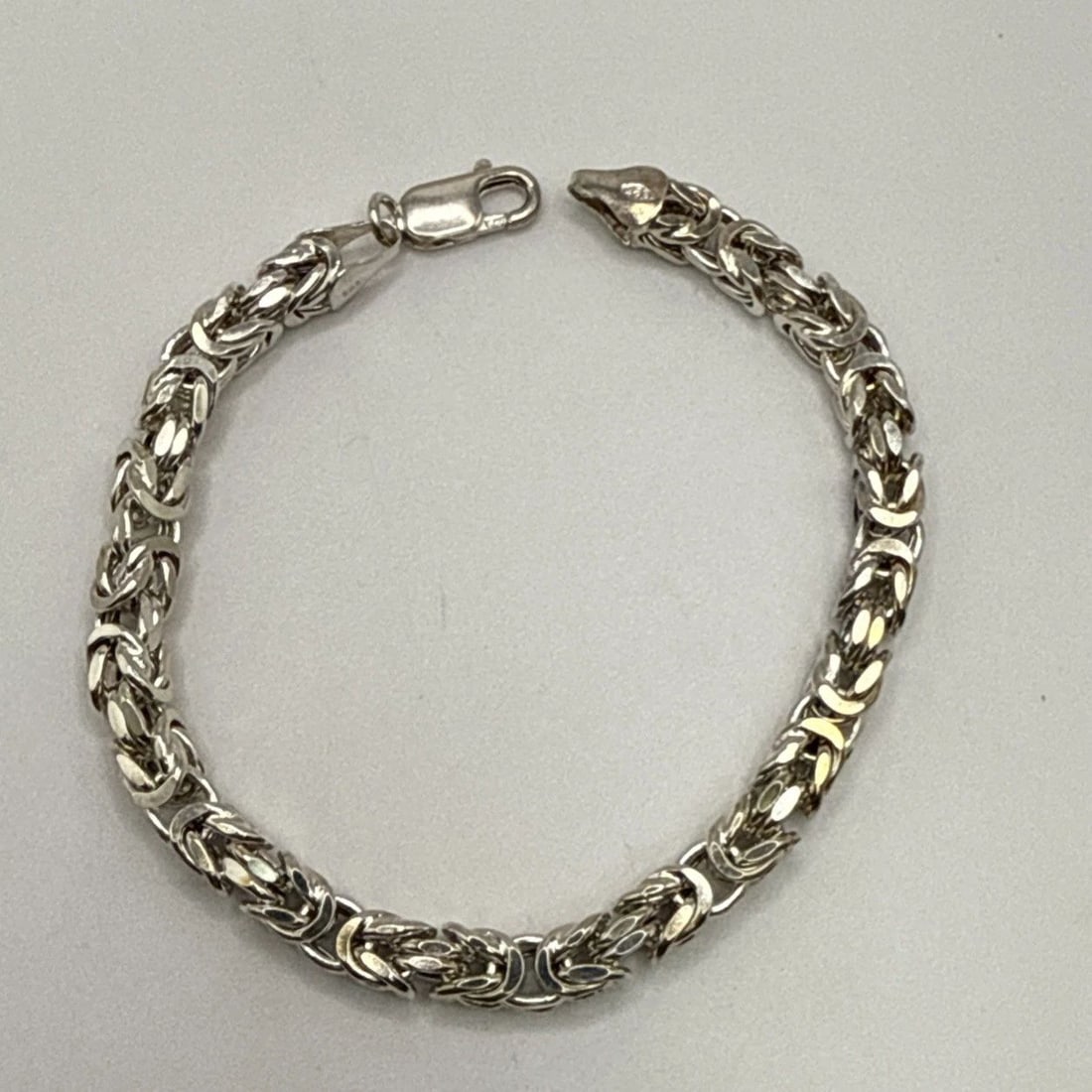 FANCY LINK 7.5" STERLING SILVER BRACELET 13.6 GRAMS: FANCY LINK 7.5" STERLING SILVER BRACELET 13.6 GRAMS The Fancy Link 7.5" Sterling Silver Bracelet weighs 13.6 grams and is crafted from high-quality 925 sterling silver. The chain style bracelet featur