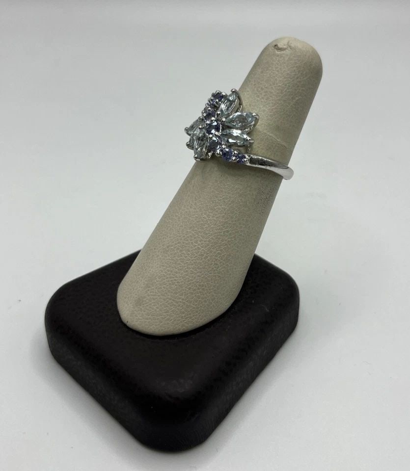 TANZANITE AND COLORLESS STONE FLORAL CLUSTER STERLING SILVER RING SIZE 7.25: TANZANITE AND COLORLESS STONE FLORAL CLUSTER STERLING SILVER RING SIZE 7.25 TANZANITE AND COLORLESS STONE FLORAL CLUSTER STERLING SILVER RING SIZE 7.25 This exquisite floral cluster ring is made of hi