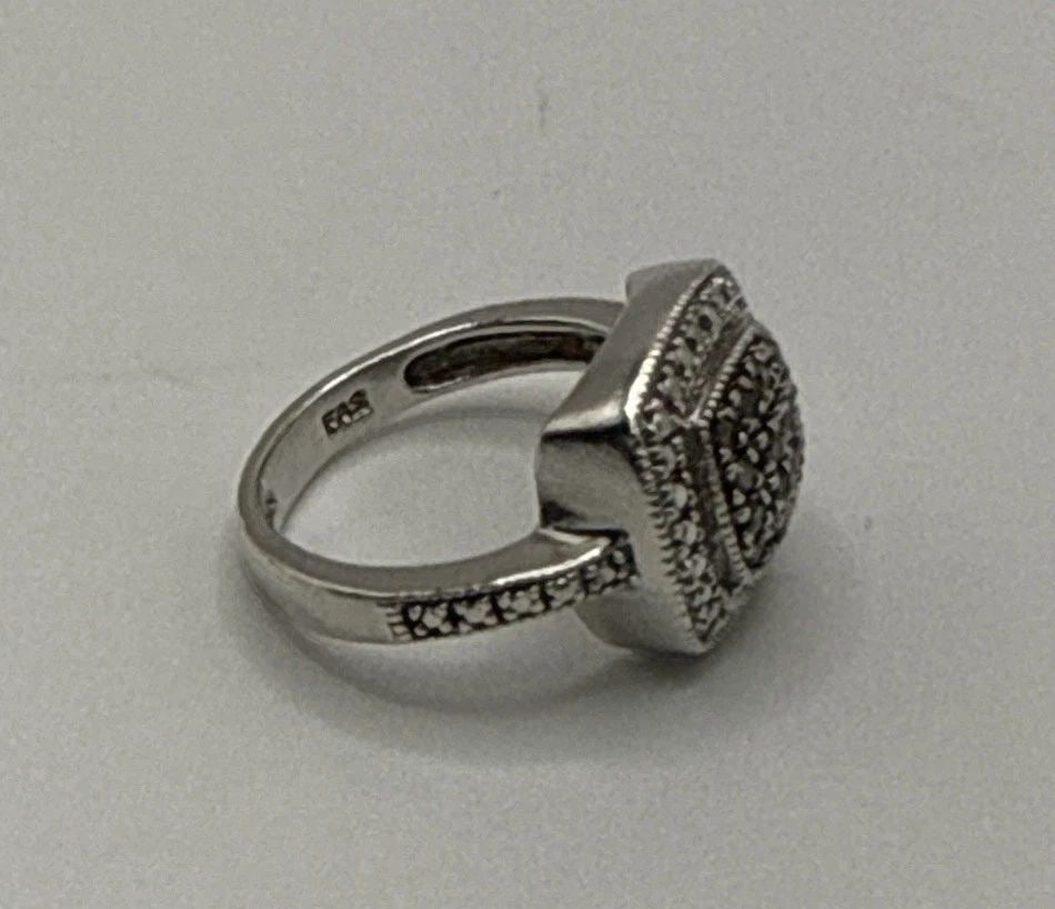STERLING SILVER MARCASITE SQUARE RING SIZE 4.75: STERLING SILVER MARCASITE SQUARE RING SIZE 4.75 The Sterling Silver Marcasite Square Ring in size 4.75 is a beautifully crafted piece of fine jewelry. Made of high-quality 925 sterling silver, this ri