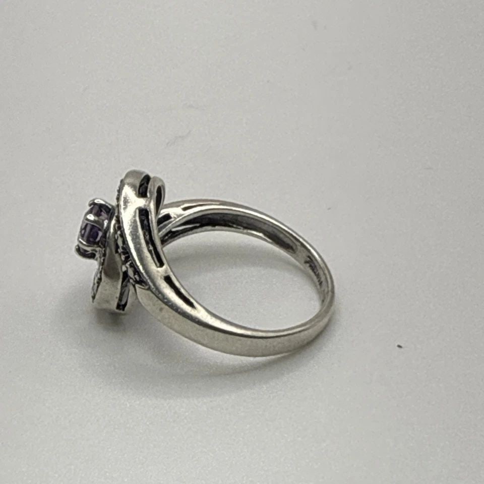 STERLING SILVER RING WITH PURPLE STONE & MARCASITE SIZE 5: STERLING SILVER RING WITH PURPLE STONE & MARCASITE SIZE 5 This Sterling Silver Ring with a Purple Stone & Marcasite is a stunning piece of fine jewelry. The ring is crafted with 925 sterling silver an