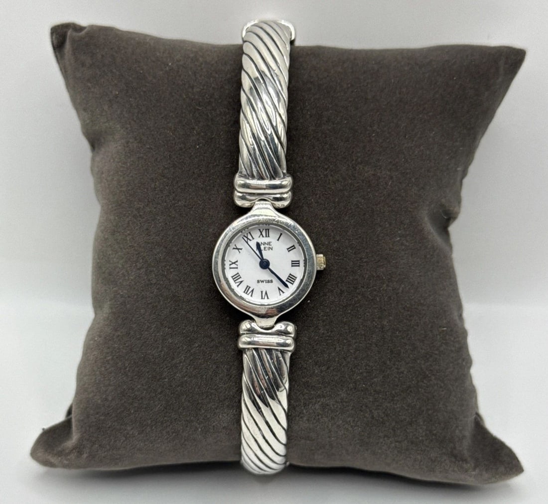 ANNE KLEIN WATCH STERLING SILVER VINTAGE BANGLE 925 WOMEN'S HEAVY 52.6 GRAMS: ANNE KLEIN WATCH STERLING SILVER VINTAGE BANGLE 925 WOMEN'S HEAVY 52.6 GRAMS This vintage Anne Klein watch features a quartz movement with Roman numerals and a 24-hour dial on a white face. The bangle