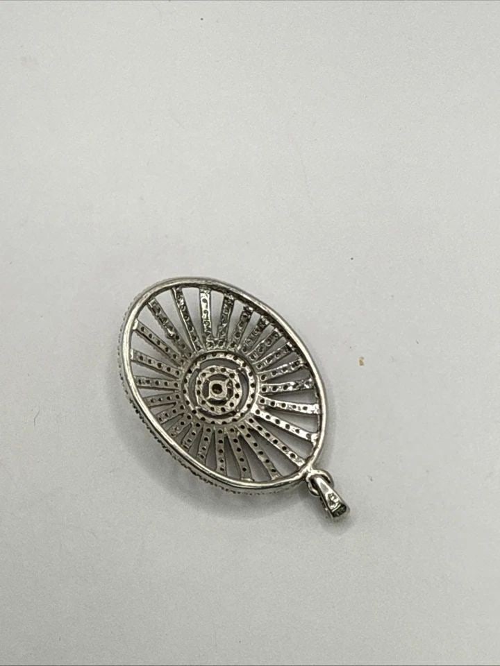 OPENWORK STERLING SILVER & SINGLE CUT DIAMONDS OVAL PENDANT: OPENWORK STERLING SILVER & SINGLE CUT DIAMONDS OVAL PENDANT This Sterling Silver & Single Cut Diamonds Oval Pendant is a luxurious piece of fine jewelry that exudes elegance and sophistication. Crafte