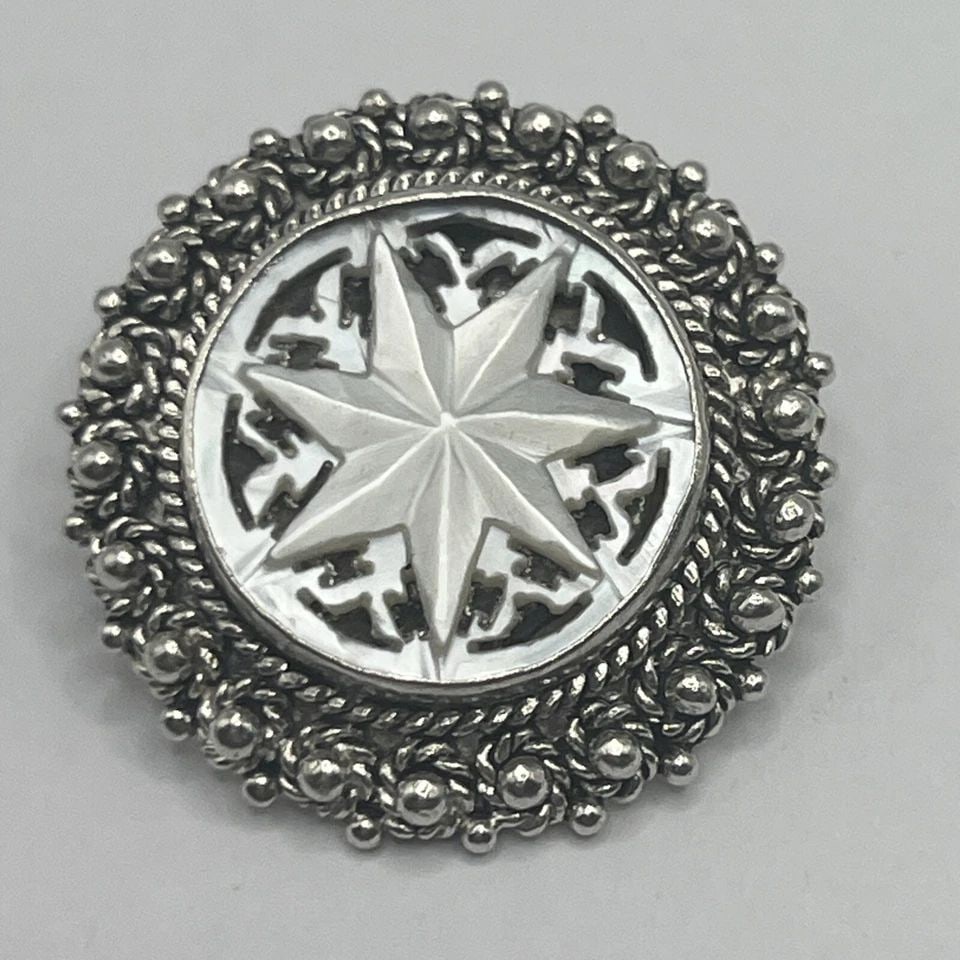 JERUSALEM SILVER CLIP EARRINGS WITH CARVED MOTHER OF PEARL FLOWER DESIGN: JERUSALEM SILVER CLIP EARRINGS WITH CARVED MOTHER OF PEARL FLOWER DESIGN JERUSALEM SILVER CLIP EARRINGS WITH CARVED MOTHER OF PEARL FLOWER DESIGN These statement clip earrings are crafted in silver wi