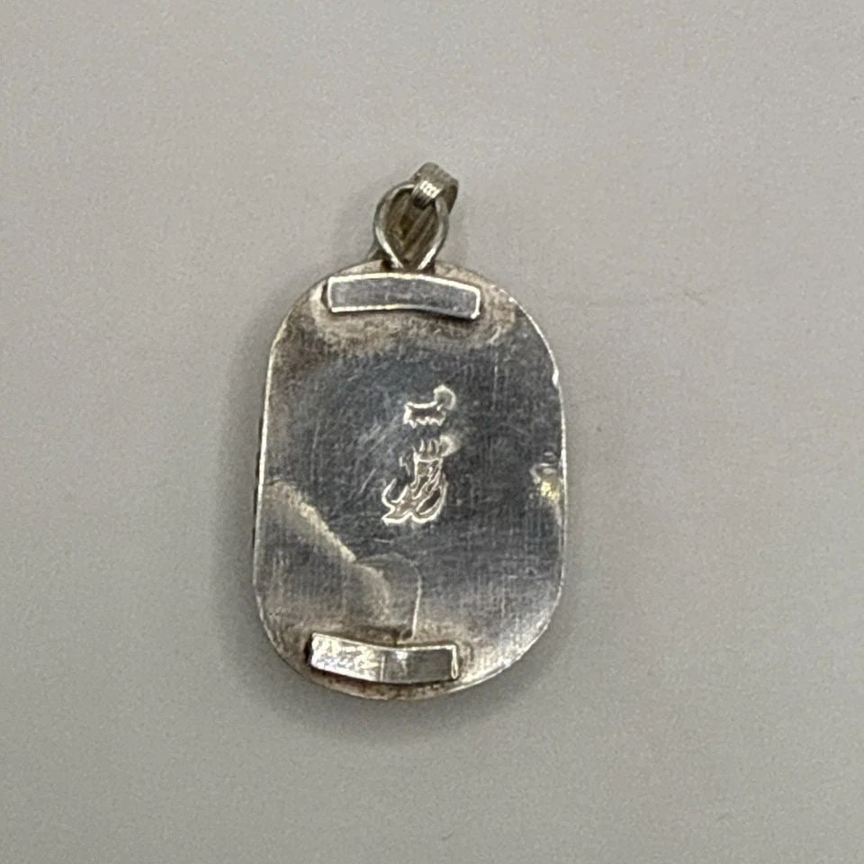 STERLING SILVER & TURQUOISE PENDANT: STERLING SILVER & TURQUOISE PENDANT This Native American sterling silver pendant features a beautiful turquoise stone in a vibrant blue color. The pendant is crafted with 925 sterling silver and showc