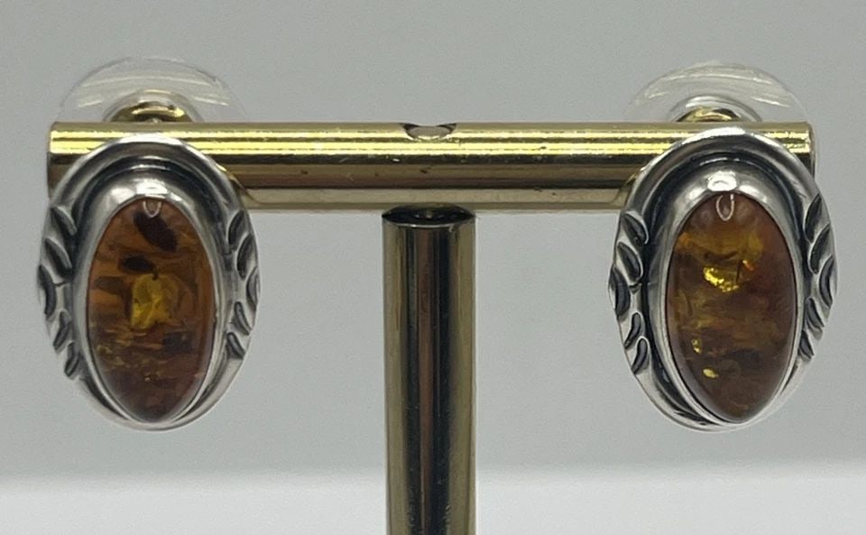 STERLING SILVER & AMBER EARRINGS: STERLING SILVER & AMBER EARRINGS STERLING SILVER & AMBER EARRINGS These Sterling Silver & Amber Earrings feature a stunning design with cognac-colored amber stones set in 925 sterling silver. The stud