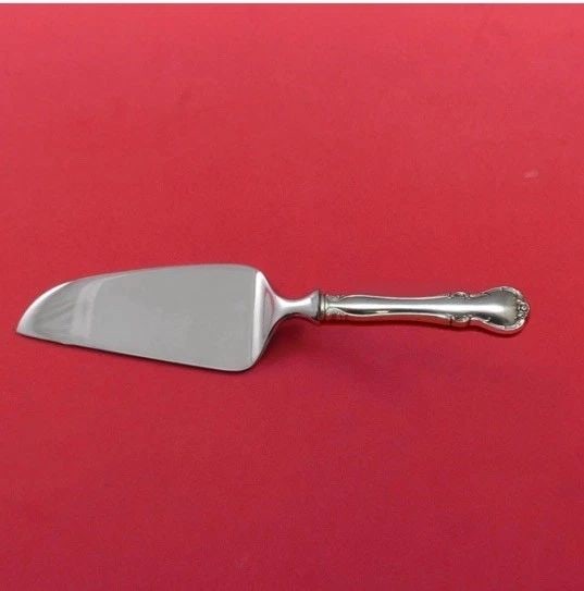 FRENCH PROVINCIAL BY TOWLE STERLING SILVER FLATWARE, CHEESE SERVER: FRENCH PROVINCIAL BY TOWLE STERLING SILVER FLATWARE, CHEESE SERVER The French Provincial cheese server by Towle is a luxurious addition to any dining table. Made of sterling silver, this serving piece