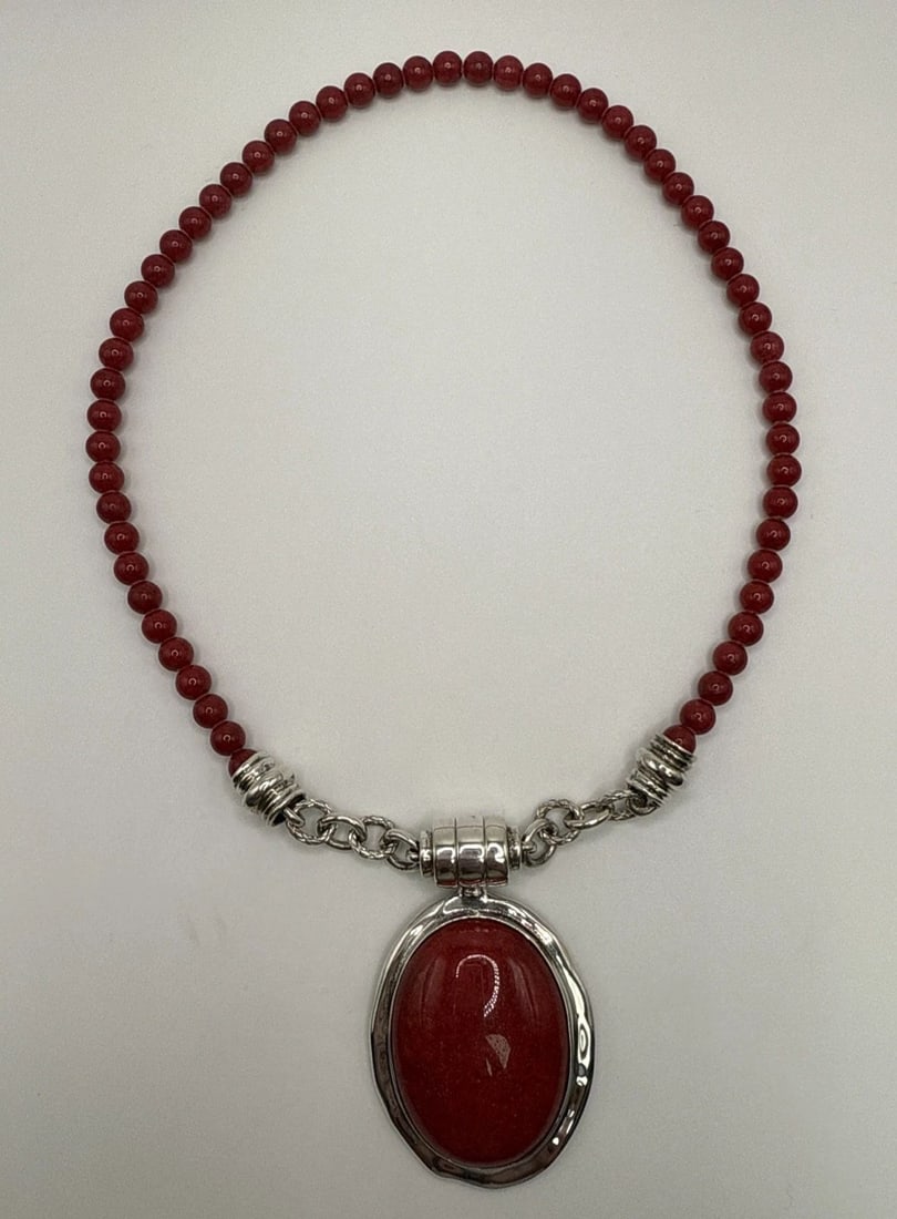 STERLING SILVER & RED CORAL BEADED 17" NECKLACE WITH LARGE PENDANT: STERLING SILVER & RED CORAL BEADED 17" NECKLACE WITH LARGE PENDANT This necklace features a 17" chain made of sterling silver with a large oval pendant adorned with red coral beads. The combination of