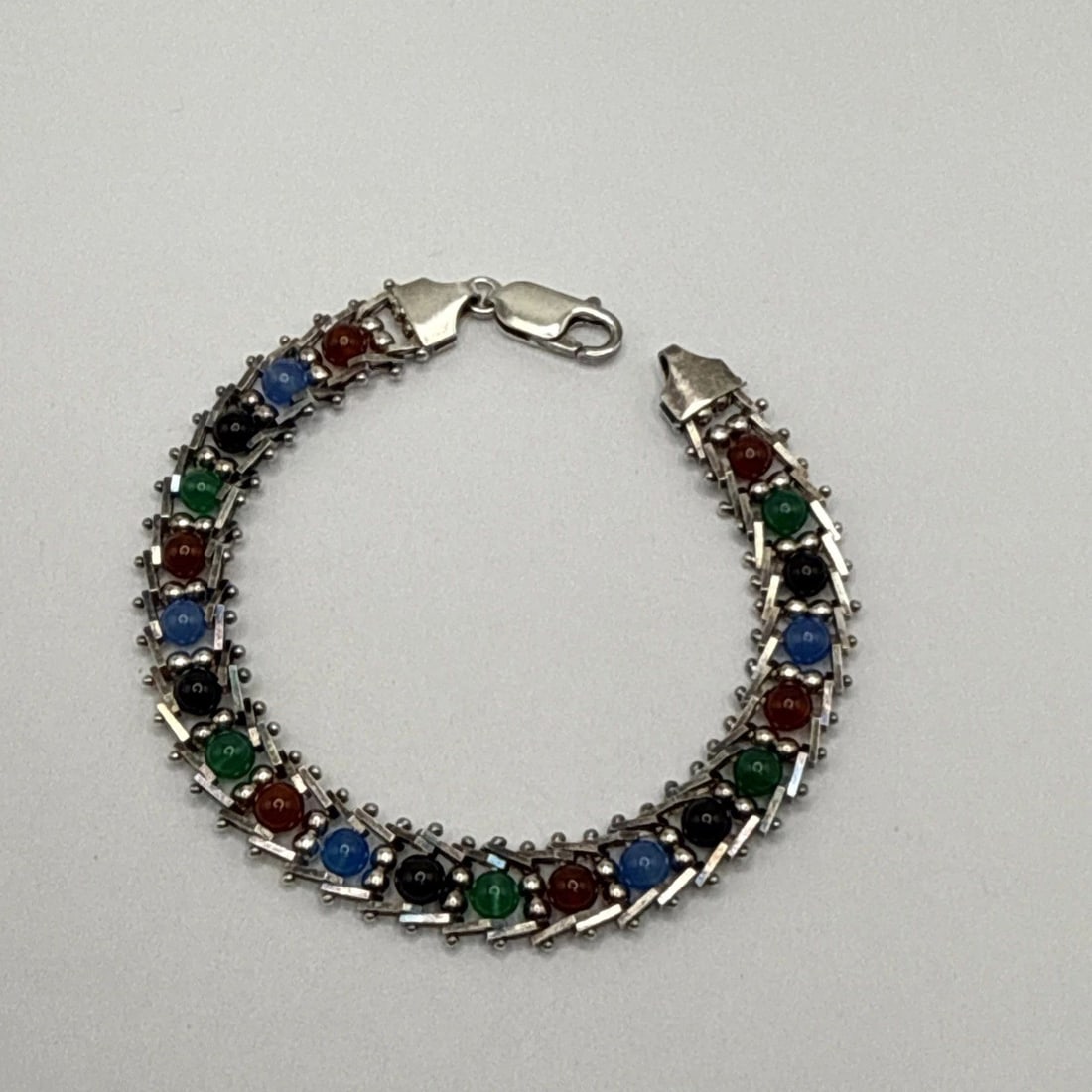 7" STERLING SILVER & MULTICOLORED STONE BRACELET: 7" STERLING SILVER & MULTICOLORED STONE BRACELET 7" STERLING SILVER & MULTICOLORED STONE BRACELET Crafted by the reputable brand Milor, this 7-inch tennis bracelet showcases a striking array of multic
