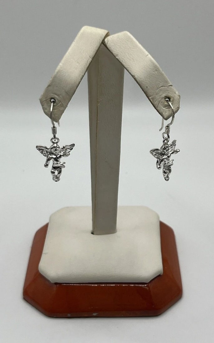 STERLING SILVER ANGEL EARRINGS: STERLING SILVER ANGEL EARRINGS STERLING SILVER ANGEL EARRINGS Enhance your style with these stunning Sterling Silver Angel Earrings. Crafted with 925 metal purity, these dangle/drop earrings are perfe