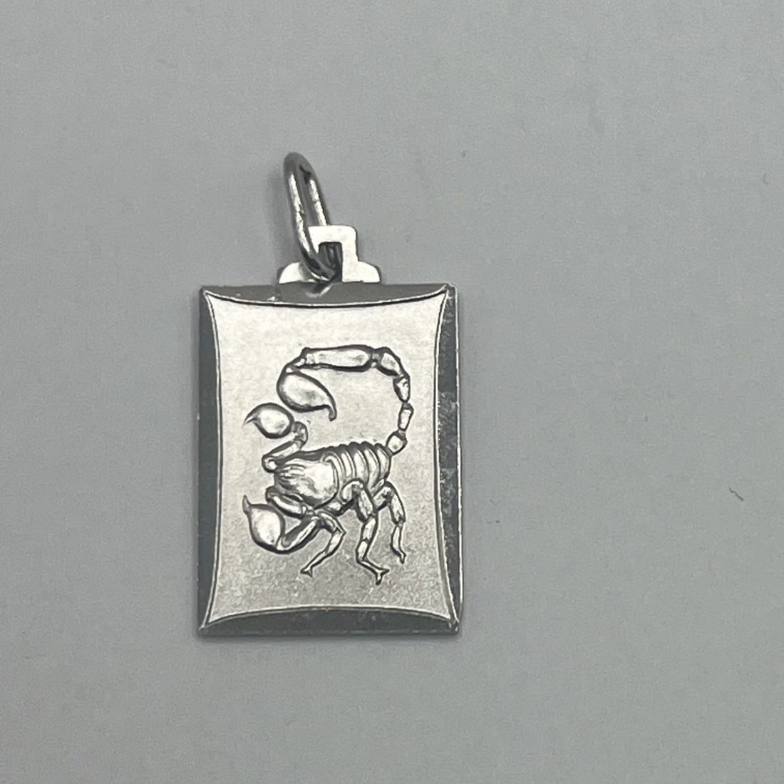 SCORPIO STERLING SILVER CHARM: SCORPIO STERLING SILVER CHARM SCORPIO STERLING SILVER CHARM The Scorpio Sterling Silver Charm features the zodiac sign of Scorpio on a 925 sterling silver charm. This charm is a part of the Silver Cha