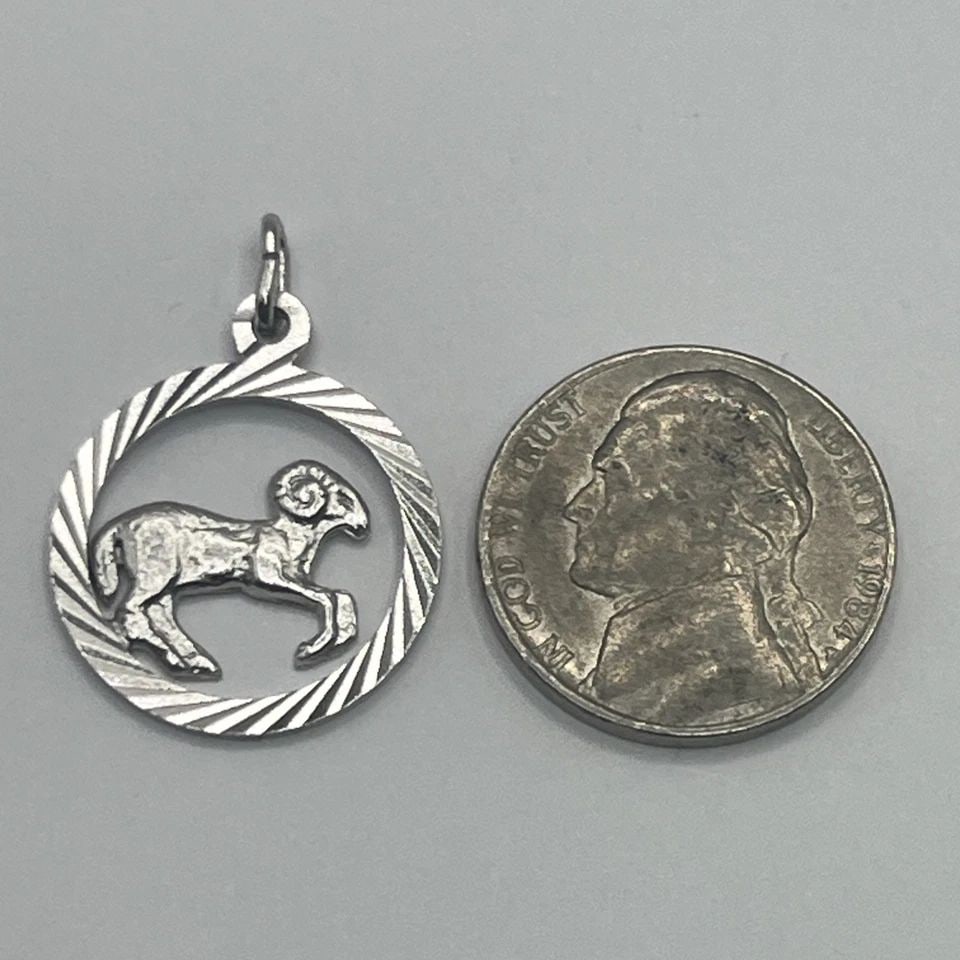 ARIES STERLING SILVER CHARM: ARIES STERLING SILVER CHARM ARIES STERLING SILVER CHARM The "Aries Sterling Silver Charm" features a sterling silver charm designed with the Aries zodiac sign. The charm is crafted with metal purity o