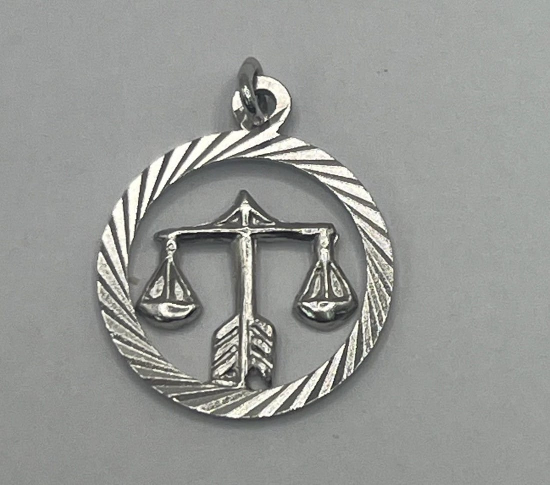 LIBRA STERLING SILVER CHARM: LIBRA STERLING SILVER CHARM LIBRA STERLING SILVER CHARM The "Libra Sterling Silver Charm" is a charming accessory designed for individuals born under the Libra zodiac sign. Crafted from 925 sterling s