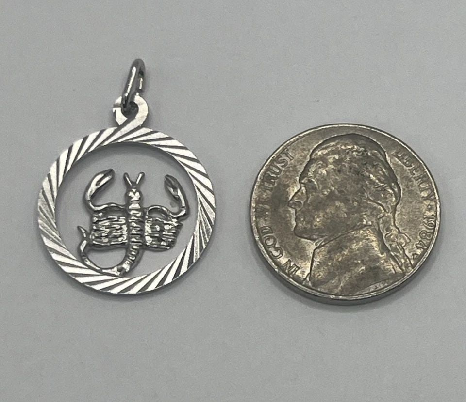 SCORPIO STERLING SILVER CHARM: SCORPIO STERLING SILVER CHARM SCORPIO STERLING SILVER CHARM The Scorpio Sterling Silver Charm features the zodiac sign charm of Scorpio, crafted in 925 sterling silver. This charm is designed to be co