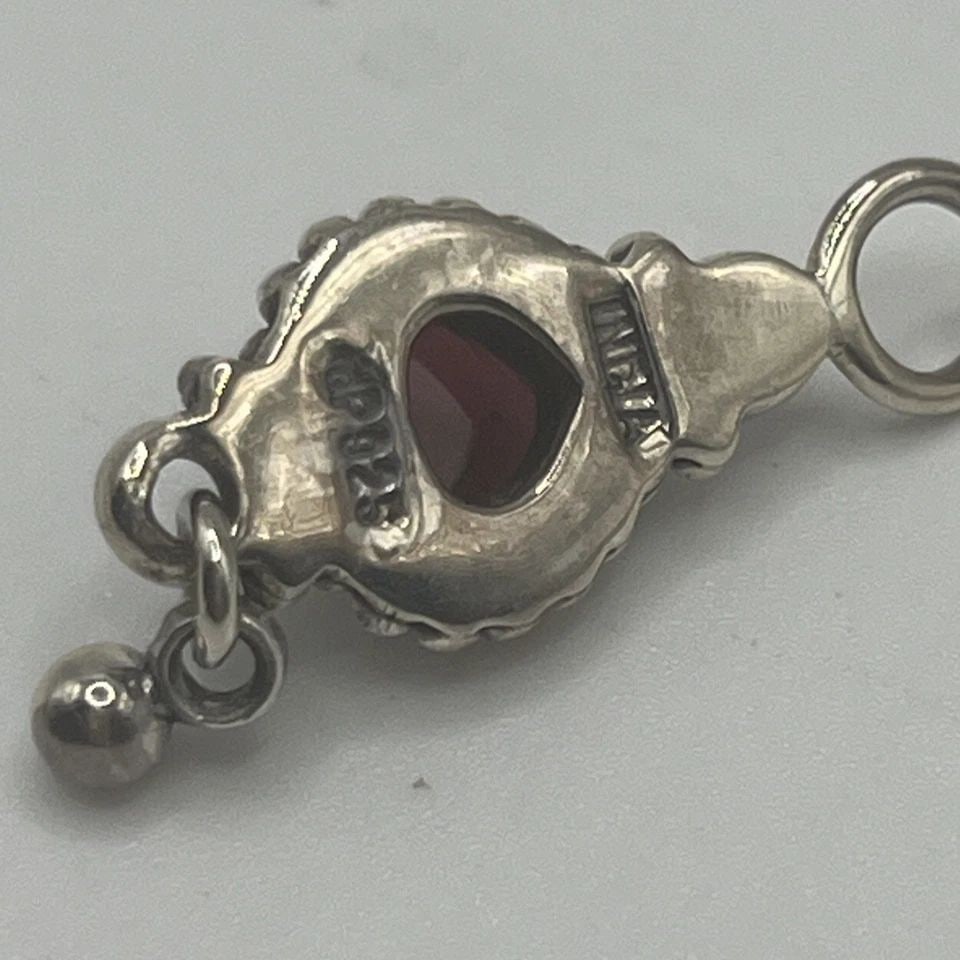 MINI STERLING SILVER MADE IN INDIA PENDANT WITH DEEP RED STONE: MINI STERLING SILVER MADE IN INDIA PENDANT WITH DEEP RED STONE MINI STERLING SILVER MADE IN INDIA PENDANT WITH DEEP RED STONE Add a touch of elegance to your collection with this beautiful Mini Sterli