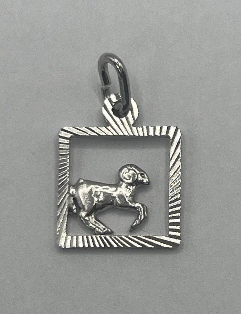 ARIES STERLING SILVER CHARM: ARIES STERLING SILVER CHARM ARIES STERLING SILVER CHARM The "Aries Sterling Silver Charm" features the Zodiac sign Aries on a sterling silver charm. The charm is crafted with a metal purity of 925, in