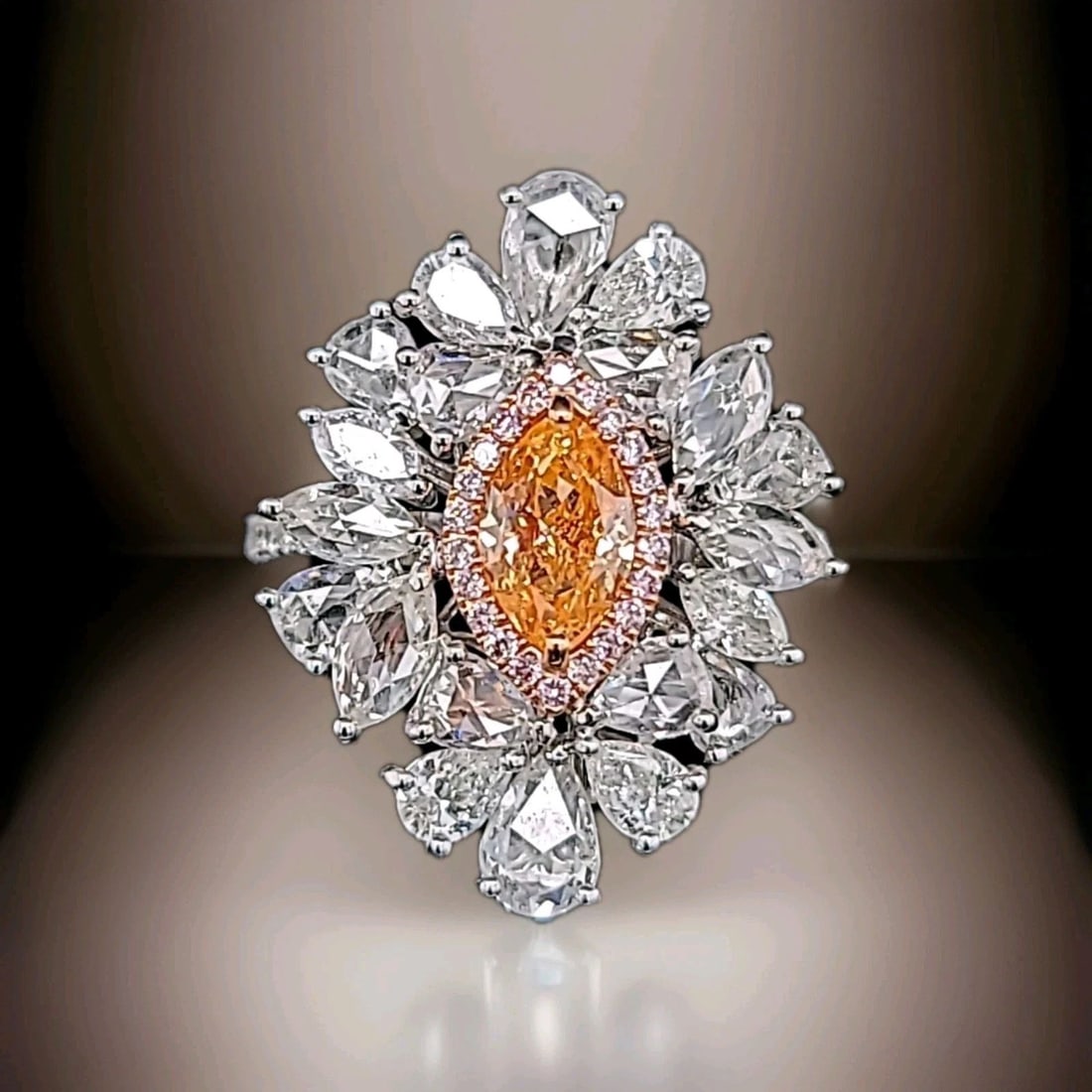 18k White Gold Statement Ring 0.85ct.Natural Fancy Orange Diamond Marquise Cut: 18K WHITE GOLD STATEMENT RING 0.85CT.NATURAL FANCY ORANGE DIAMOND MARQUISE CUT This stunning 18k white gold ring is a true statement piece. The marquise cut natural fancy orange diamond is the star of