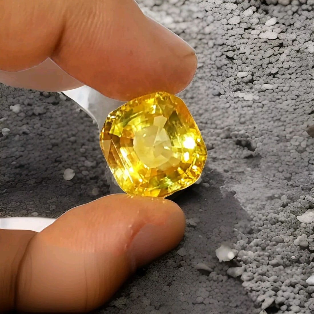 20.12ct. Natural Yellow Sapphire Loose Gemstone Cushion: 20.12CT. NATURAL YELLOW SAPPHIRE LOOSE GEMSTONE CUSHION This stunning cushion-cut yellow sapphire is a truly natural gemstone, with a total carat weight of 20.12. The gemstone boasts a very good cut g