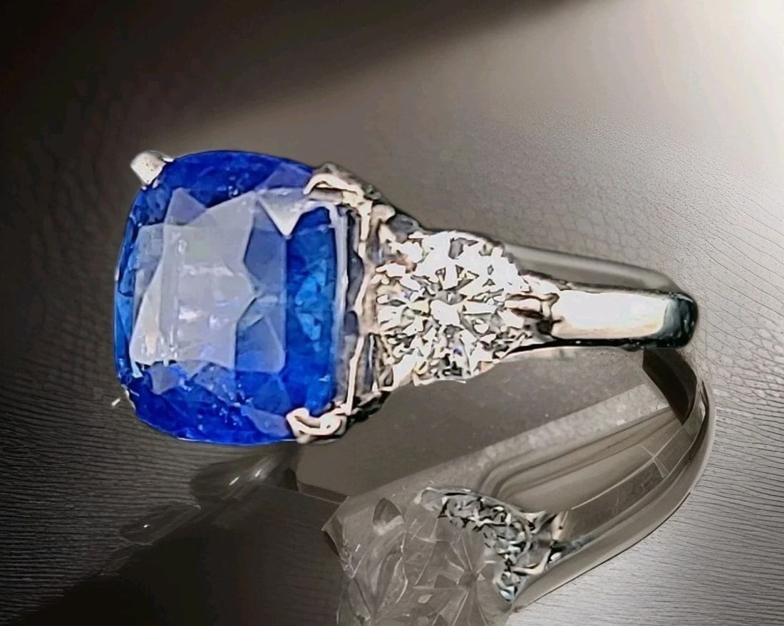 Vintage 14k White Gold Engagement Ring 4.88ct Natural Cushion Blue Sapphire GIA: VINTAGE 14K GOLD ENGAGEMENT RING 4.88CT CUSHION SHAPE BLUE SAPPHIRE GIA CERT This vintage engagement ring features a stunning 4.88ct cushion-shaped blue sapphire set in a three-stone setting with two 